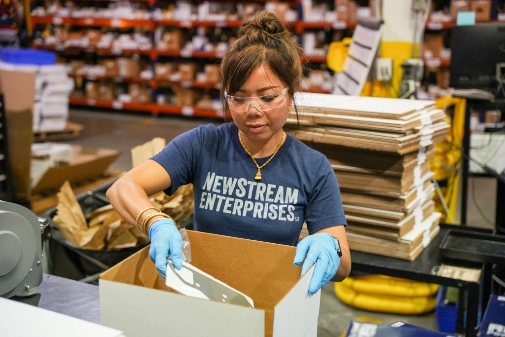 NewStream employee packaging parts for shipment
